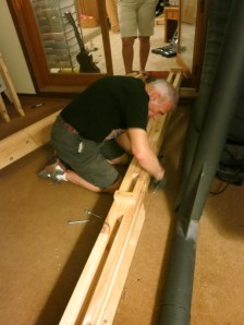 My Dad, Marshall, fastens 3 bolts to secure the lap joints for the left main support beam.