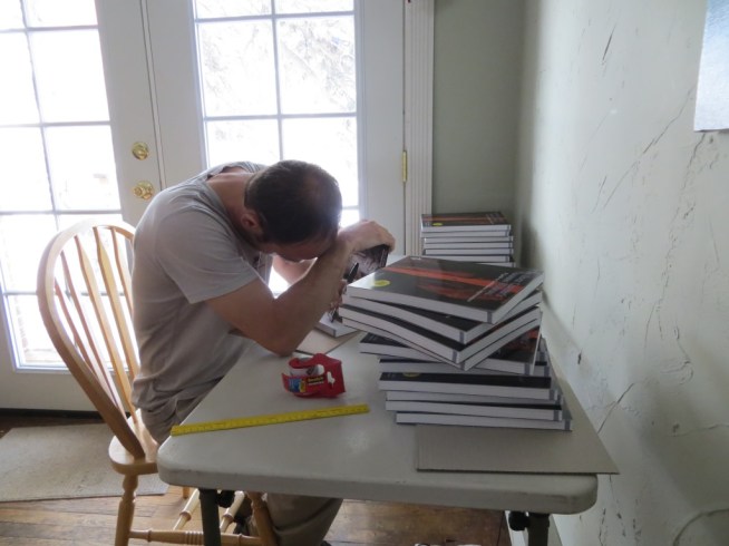 Signing books and stuffing envelopes.