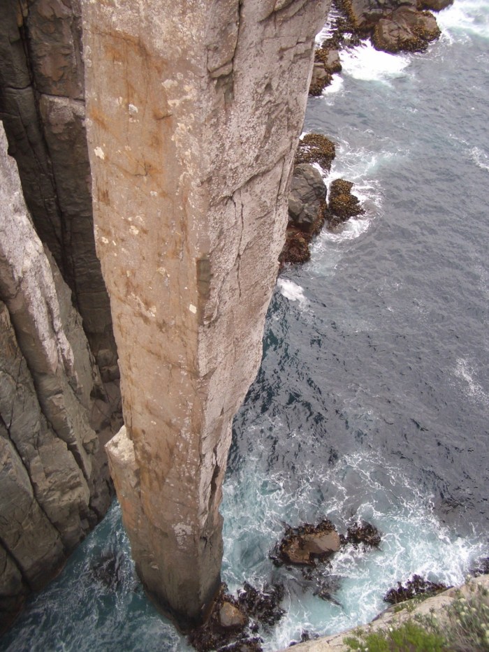 Ya...no shit!  The first pitch starts up the left side of the central arete, traverses the dark gray rock (crux) to reach the right arete, then climbs around the arete to the hidden face, ending on the obvious ledge on the left arete.  The second pitch climbs the left arete and the hidden face to its left.