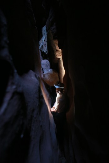 Deep in the slot it was so dark we needed a headlamp, but when we lit it up, we could see the walls were covered with spiders!