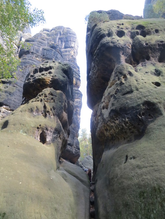 Kate peeking through a narrow chasm below the north side of the Schrammtorwachter.