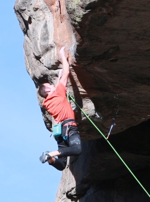 Working along the lip to reach better holds.  Photo Mike Anderson.