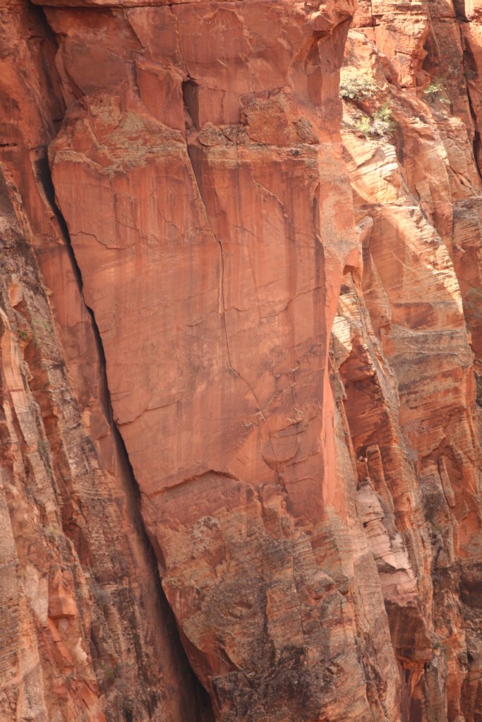 Pitch 4 of Rub it Raw - Starting from a nice ledge, it climbs a slightly overhanging, arching splitter that starts with a 1