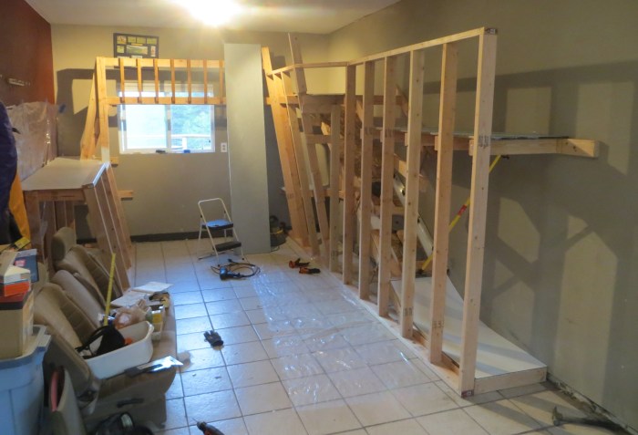 Gluing wainscoted (whiteboard) panels onto the slide. It took as much effort to build the slide as it did to build the rest of the wall! But it was worth it—the slide is by far the most popular feature. 