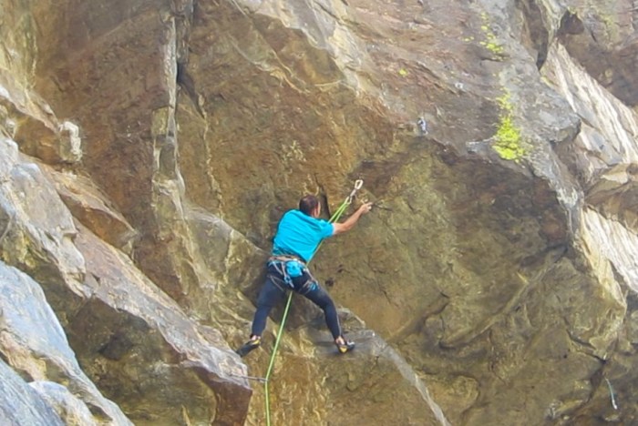 Reaching up to undercling the remains of the big flake. After matching the undercling, you have to make a huge reach to a 3-finger edge along the crescent shaped rail near the bottom of the lime streak.